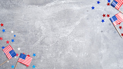 Frame made of American flags and confetti stars on concrete stone. Banner template for USA Memorial day, Presidents day, Veterans day, Labor day, or 4th of July celebration. With copy space for text