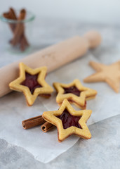 Biscotti a forma di stella farciti con confettura di lamponi