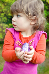 cute little girl looking for easter eggs