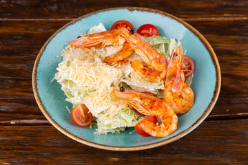 Salad with shrimp, grated parmesan cheese and salad leaves