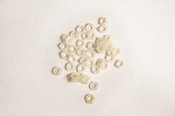 Elastic rubber arches, bands for braces that are installed on the teeth on a light background, top view