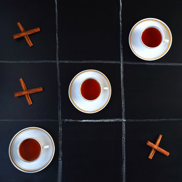 TIC-TAC-toe game of tea and cinnamon sticks. Concept of the game TIC-TAC-toe