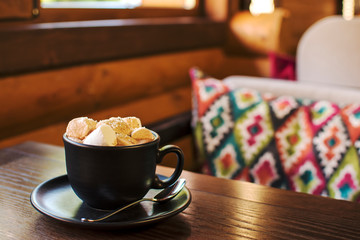 Cup of hot cacao with marshmallow, cinnamon and nuts ,close up.
