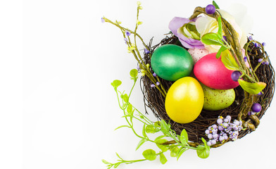 happy Easter, colored eggs in a basket and spring flowers on a white background, spring Orthodox Christian and Catholic holiday, banner with space for text