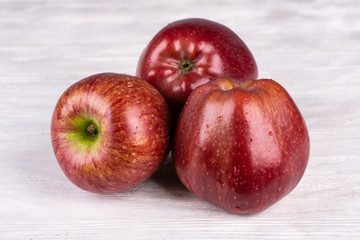 Crass apples of the highest grade on a white wooden background
