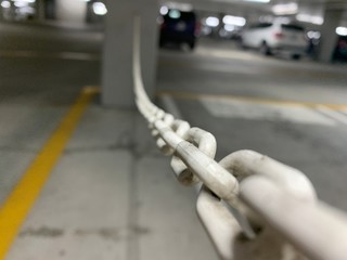 Naklejka premium Close up of plastic chain in parking lot