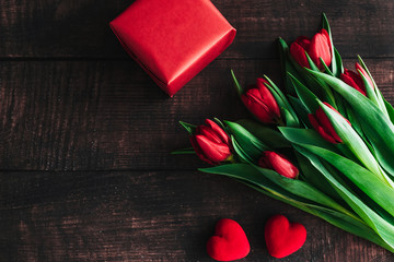 Bouquet of red tulips on a wooden background. Spring flowers. Mother's Day background.