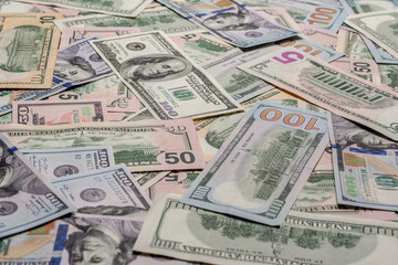 The dominant currency of the world, dollar bills in textured form.