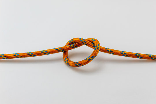 overhand knot orange rope example, white background, isolated