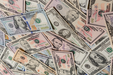 Close up dollar texture, dollars in denominations of five, ten, twenty, fifty, one hundred.