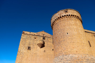  Towers of medieval spanish castle La Calahorra on the hill against azure winter sky
