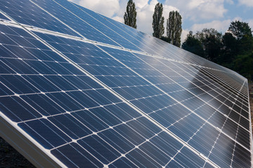 Photovoltaic power plant panels for extracting energy from the sun. In the background sunny blue...