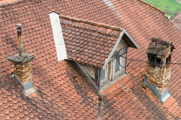 roof tile of a house with chimney and dormer