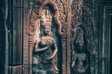 Wall in Angkor Wat - Hindu temple complex in Cambodia, largest religious monument in the world. Popular tourist attraction. Interior detail view. Cambodia, Siem Reap