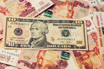 Texture of various international banknotes and paper money, 10 dollars on the background of 5000 rubles.