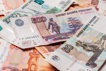 The texture of banknotes in denominations of 5000, 1000, 500 and 50 Russian rubles.