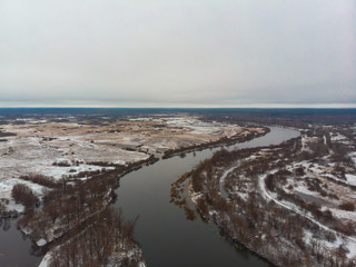 Winter nature, forest, river, village. View from above. Shooting from a copter.