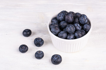 Blueberries washed, fresh in ceramic plaid on white background