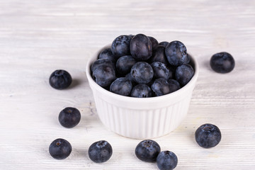 Large blueberry on white wooden background in plaid