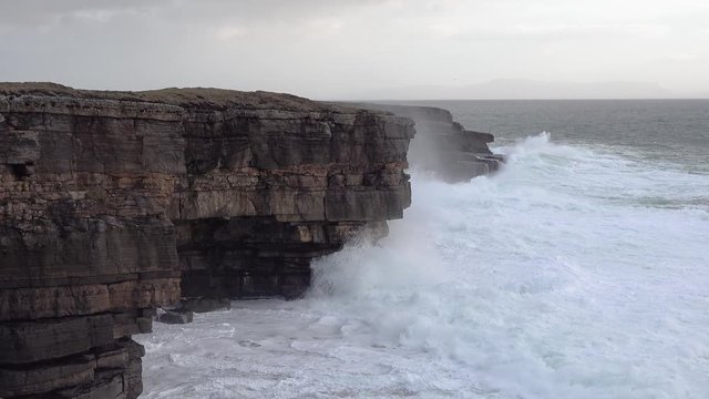 Huge waves breaking at Muckross Head - A small peninsula west of Killybegs, County Donegal, Ireland. The cliff rocks are famous for climbing
