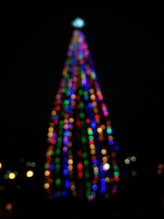 christmas tree on black background with lights, defocused, bokeh blur