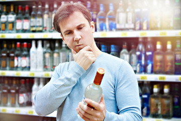 Man chooses bottle of vodka