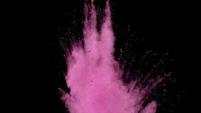 Realistic pink powder dust explosion on black background. Slow motion movement of dust remains