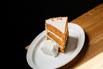 Piece of carrot cake on table