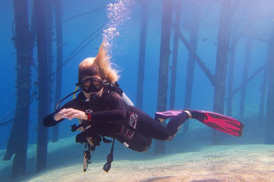 Scuba diving woman in the crystal clear water