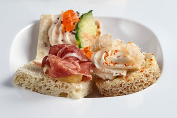 Assortment of various appetizer canapes on plate