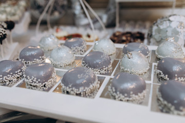 Tasty grey mousse desserts on the candy bar