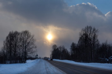 Russia. South Of Western Siberia. Picturesque cold sunset on a snow-covered road in The mountain Shoria.