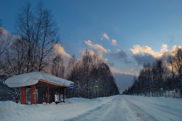 Russia. South Of Western Siberia. Picturesque cold sunset on a snow-covered road in The mountain Shoria.