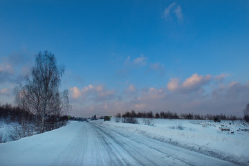 Russia. South Of Western Siberia. Picturesque cold sunset on a snow-covered road in The mountain Shoria.