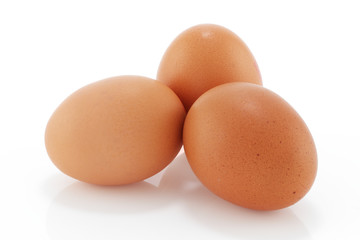 Fototapeta na wymiar Three brown chicken eggs on a white background