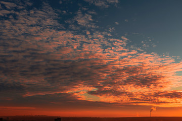 Beautiful sky with clouds over the city at sunset