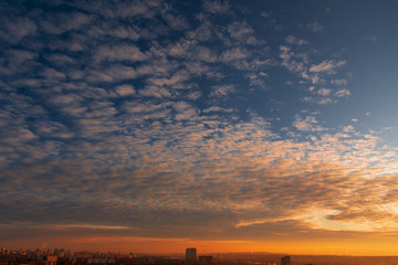 Beautiful sky with clouds over the city at sunset