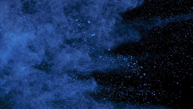Realistic blue powder explosion on black background. Slow motion movement with acceleration from left of screen.