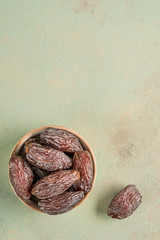 closeup of delicious date fruits on a green background