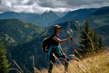 A young woman is climbing a mountain.