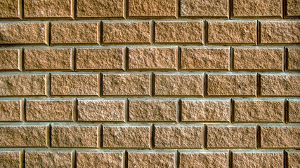 The yellow wall is tiled with torn bricks