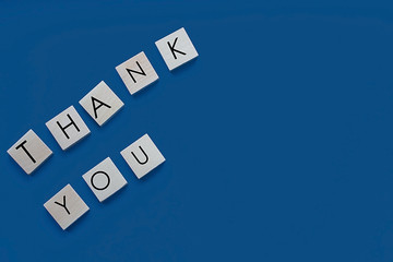 Thank you words from letters on a blue background. Thank you phrase, thank you concept, place for...
