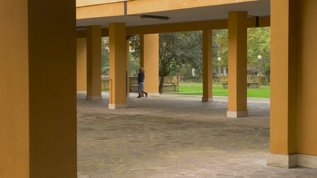 young woman walking disappears and reappears in different site - pacman effect