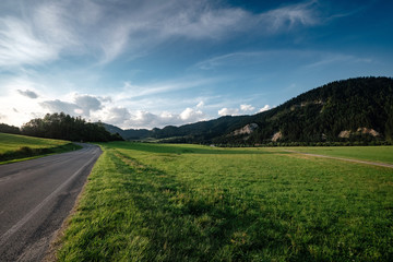 Road in mountain valley at sunny morning in Poland.