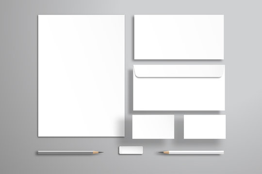 White sheet of paper or blank, two envelopes, two business cards, pencils and an eraser. Realistic mockup for design with objects that are at different levels from the surface