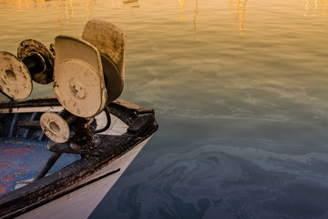 fishing boat detail over the calm sea at sunset