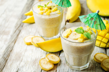 banana mango smoothie on a wood background