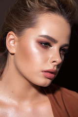 Beautiful young model with professional make up, perfect skin. Trendy red toned smokey eyes and nude lips.