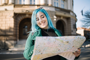 Smiling girl searching for location on a map