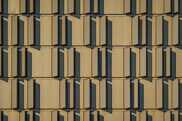 Modern building facade full of window shutters